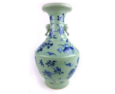 A late 18th/early 19th century Chinese vase, the pale green tapering body decorated with blue floral sprays and flanked by a 
