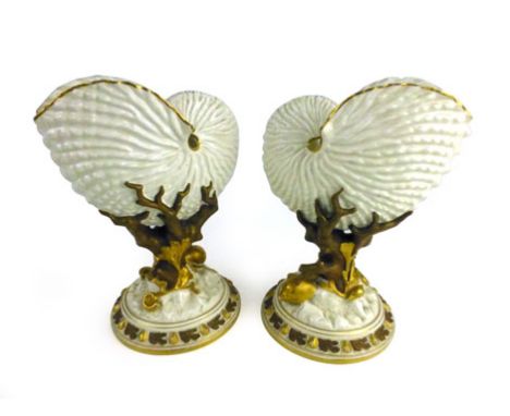 A pair of Royal Worcester nautilas vases of shell form on matching plinths, p.d.c.m. 1886, h. 21 cm CONDITION REPORT: Chip to
