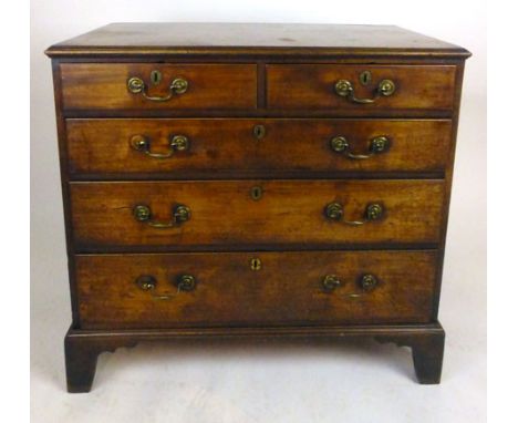 A George III mahogany chest of drawers, the moulded top over two short and three graduated long drawers with brass swan neck 