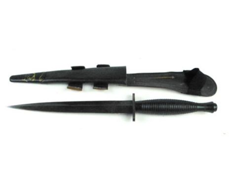 A Fairbairn Sykes style fighting knife, with an engraved arrow underneath the guard, in a leather scabbard, overall length 30