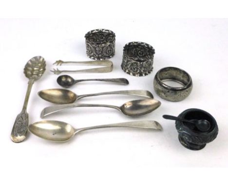 A parcel of silver hallmarked items to include three napkin rings, three teaspoons, salt, spoon, a grape design spoon, silver