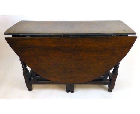 An 18th century gate leg table, the leaves supported by a double gate action with drawers either side. h. 77 cm, w. 157 cm, d