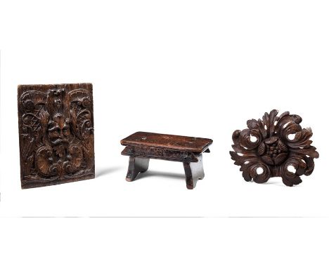 An oak ‘Green Man’ panel and a pierced foliate boss, both 17th century
Together with a small oak nailed stool, 18th century, 
