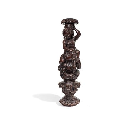 A carved walnut architectural fragment table lamp modelled as a cherub sitting on another’s shoulders, 17th century 
60cm hig