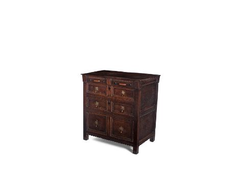 A small Charles II oak three-drawer chest, circa 1670
The frieze with dentil-mouldings and twin elongated bosses in cherrywoo