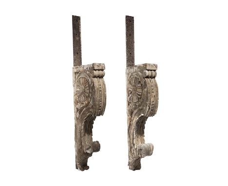 

A pair of large architectural brackets, probably 18th century
Each carved with a flower head and now with mounted iron brac