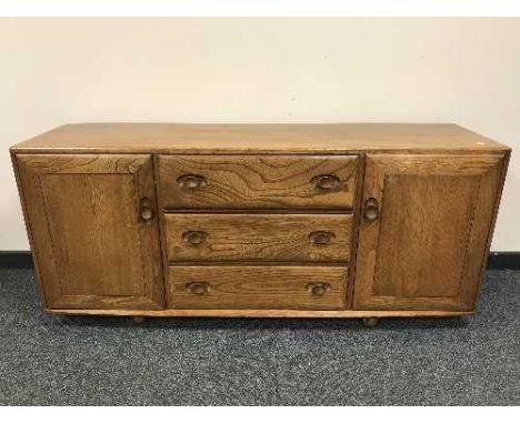 An Ercol elm low sideboard