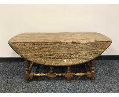 An Ercol elm drop leaf coffee table