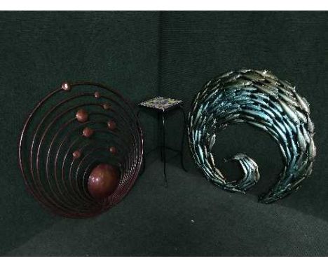A tiled topped metal plant stand and two pieces of metal wall art 