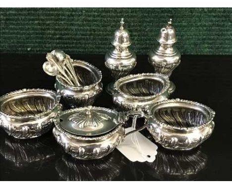 A seven piece silver cruet set by Walker & Hall, Sheffield 1901, with five matching spoons, 11.7oz gross 