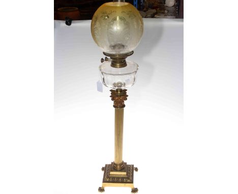 Brass columned oil lamp with glass reservoir and etched glass shade, 86cm high.