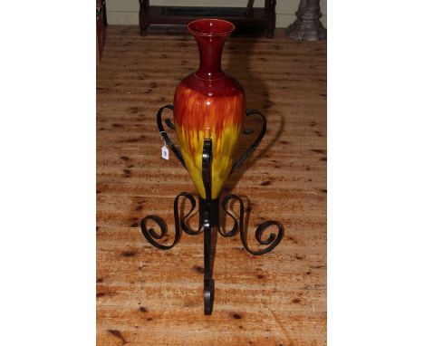 Large, probably Linthorpe pottery vase in wrought iron stand, overall height 89cm.