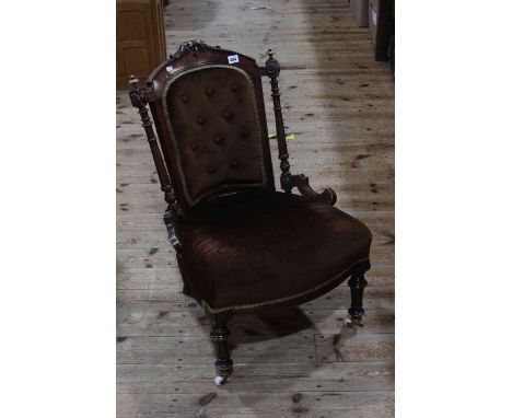Victorian walnut framed button back nursing chair on turned legs.