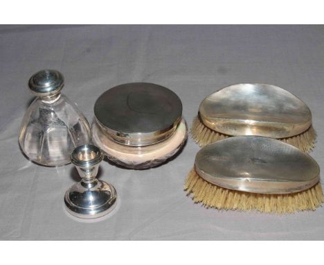 Silver topped scent bottle and powder bowl, silver backed hair brushes and silver dwarf candlestick (5).