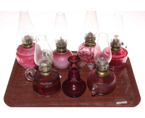 Five Victorian finger oil lamps, small ruby glass oil lamp and vase.