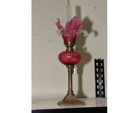 Victorian brass and ruby glass oil lamp, 41cm to top of shade.