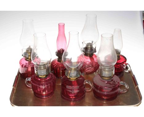 Six Victorian ruby glass finger oil lamps with chimneys and small ruby glass oil lamp (7).