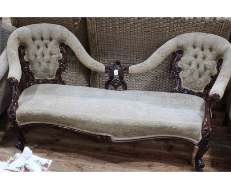 Victorian mahogany double button backed settee with serpentine front seat.