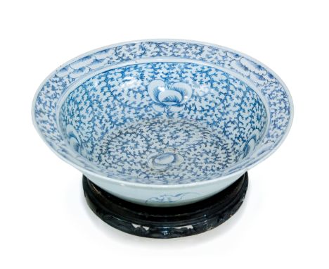 This blue and white basin is painted with twined  branch lotus decoration. No stand: H:4 3/4in(12cm) D:16in(40.6cm)