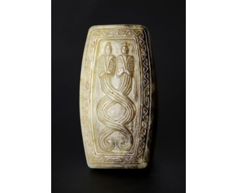 With natural inclusions, this jade toggle has been  carved with a band of geometric designs,  featuring a pair of nagas in th