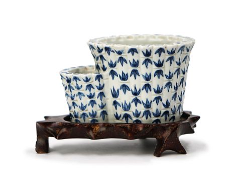Painted with bamboo leaves, this planter has two  sections and holes for drainage.  Bears a Qianlong  style mark on the botto