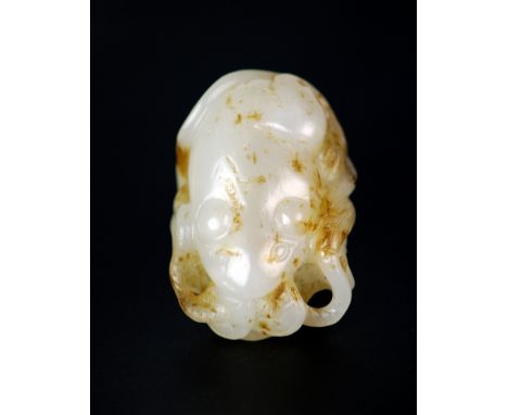 A popular symbol for prosperity, this jade money  toad holds two coins on a string in its mouth and  sits on a lotus leaf. St