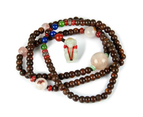 A necklace beaded with polished seed beads  punctuated with rose quartz, red, green, blue and  silver beads - ending with a c