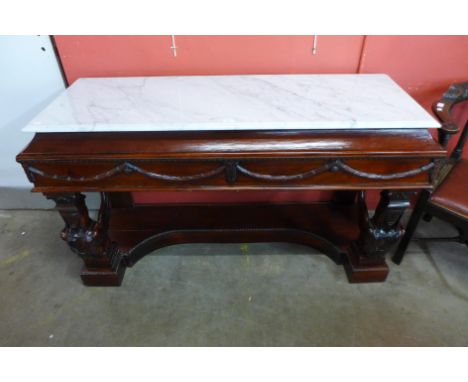 An Italian style mahogany and marble topped console table