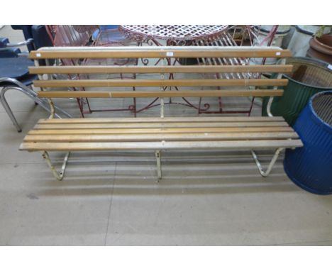 A teak and tubular steel garden bench