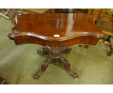 A Victorian mahogany serpentine fold over card table