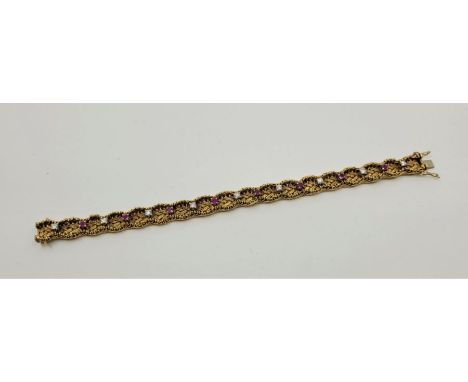 An 18ct. gold, diamond and ruby set bracelet, with part textured wire work front set nine round brilliant cut diamonds altern