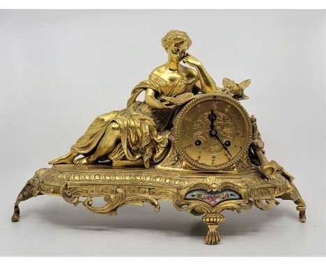 A 20th century French mantle clock, bell strike, in the classical style, fashioned as a maiden reading a book, the dial with 