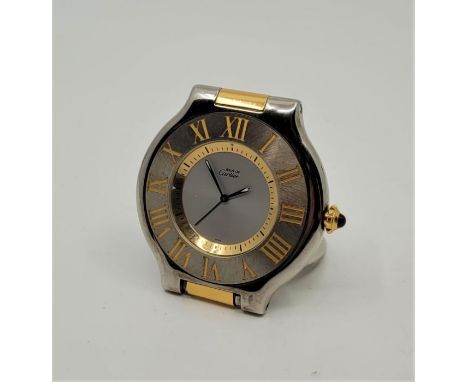 A Must de Cartier bi-colour quartz alarm table clock, with sapphire crown, signed width 5.5cm.