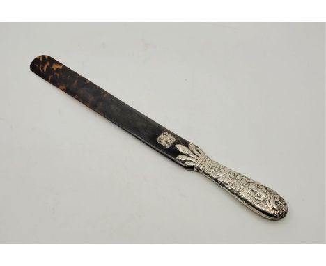 A Victorian silver mounted tortoiseshell page turner, assayed London, makers mark and date letter rubbed, the silver handle d