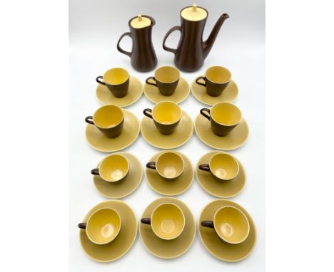 A Poole Pottery yellow and brown two-tone tea and coffee service comprising twelve cups and saucers, a teapot and a coffee po