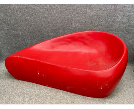A mid-century red fibreglass settee sofa of tapering kidney shape form. H.70 W.157cm.