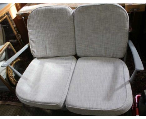 A LATER PAINTED ERCOL TWO PERSON SETTEE with fleur-de-lis back together with A LATER PAINTED ERCOL DEEP SEATED ARMCHAIR with 
