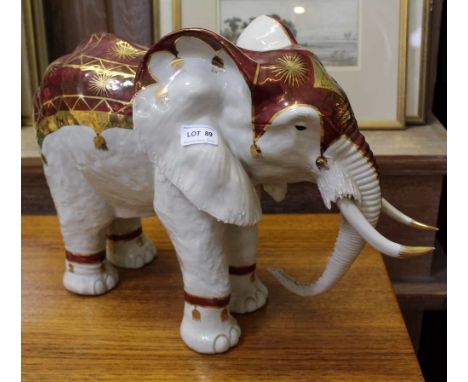 A LARGE DECORATIVELY PAINTED CERAMIC MODEL ELEPHANT 