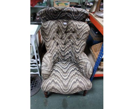 A MODERN GRAPHIC PRINT UPHOLSTERED BUTTON BACKED LOW SEATED LADY'S ARMCHAIR, supported on turned fore legs and plain rear 