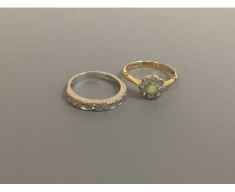 A white gold diamond half eternity ring and an 18ct gold diamond and opal cluster ring