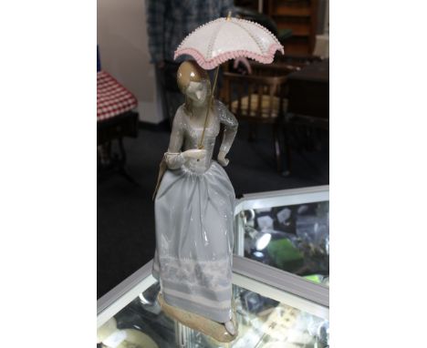 A Lladro figure - girl with parasol  CONDITION REPORT: Appears to be in good condition.