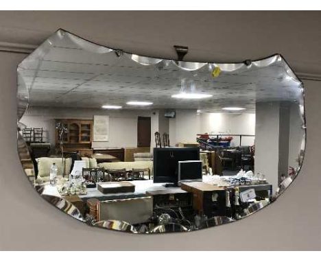 An un-framed mirror and a teak 1970's standard lamp 
