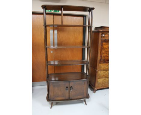 An Ercol elm open shelf room divider with a cupboard beneath  CONDITION REPORT: Typical surface wear, some scuffs and scratch