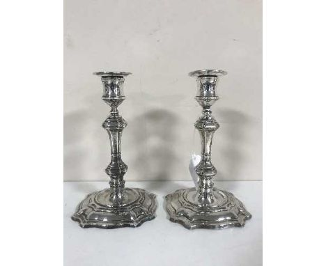 A pair of George II style silver candlesticks, William Hutton & Sons Ltd, London 1910, with sconces, 19cm (loaded)