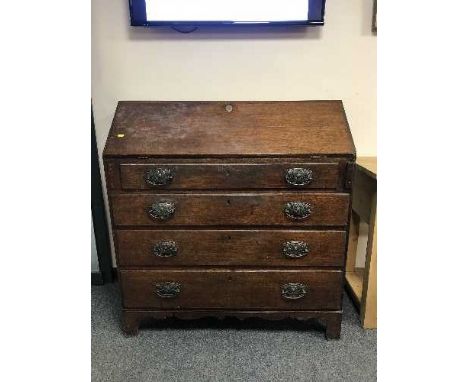 A Victorian oak bureau on bracket feet