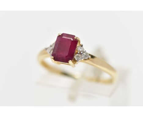 A YELLOW METAL GEM SET RING, designed with a central four claw set, rectangular cut synthetic ruby, flanked with six round br