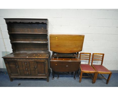 A 20TH CENTURY OAK DRESSER, the top being a two tier plate rack, the base with two cupboard doors flanking three drawers, wid