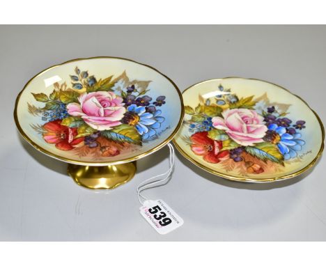 TWO AYNSLEY FLORAL DECORATED PEDESTAL DISHES BY J. A. BAILEY, with wavy rims and gilt bases, both bear signature, printed and