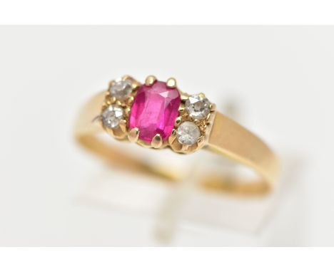 A YELLOW METAL GEM SET RING, centring on a rectangular cut synthetic ruby, flanked with three old cut diamonds also with a re
