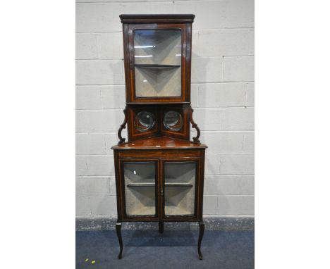 AN EDWARDIAN MAHOGANY AND BOX STRUNG CORNER CUPBOARD, top with a single glazed door, enclosing a single shelf, above two oval